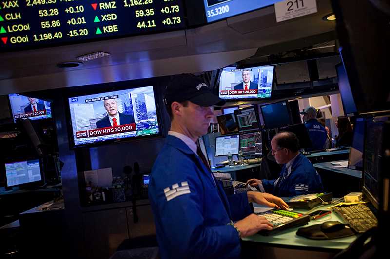 Man in front of screen at stock exchange